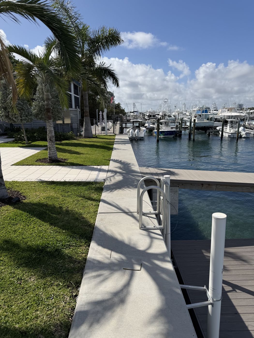 Engineered seawall cap leading to a marina filled with sportfish yachts