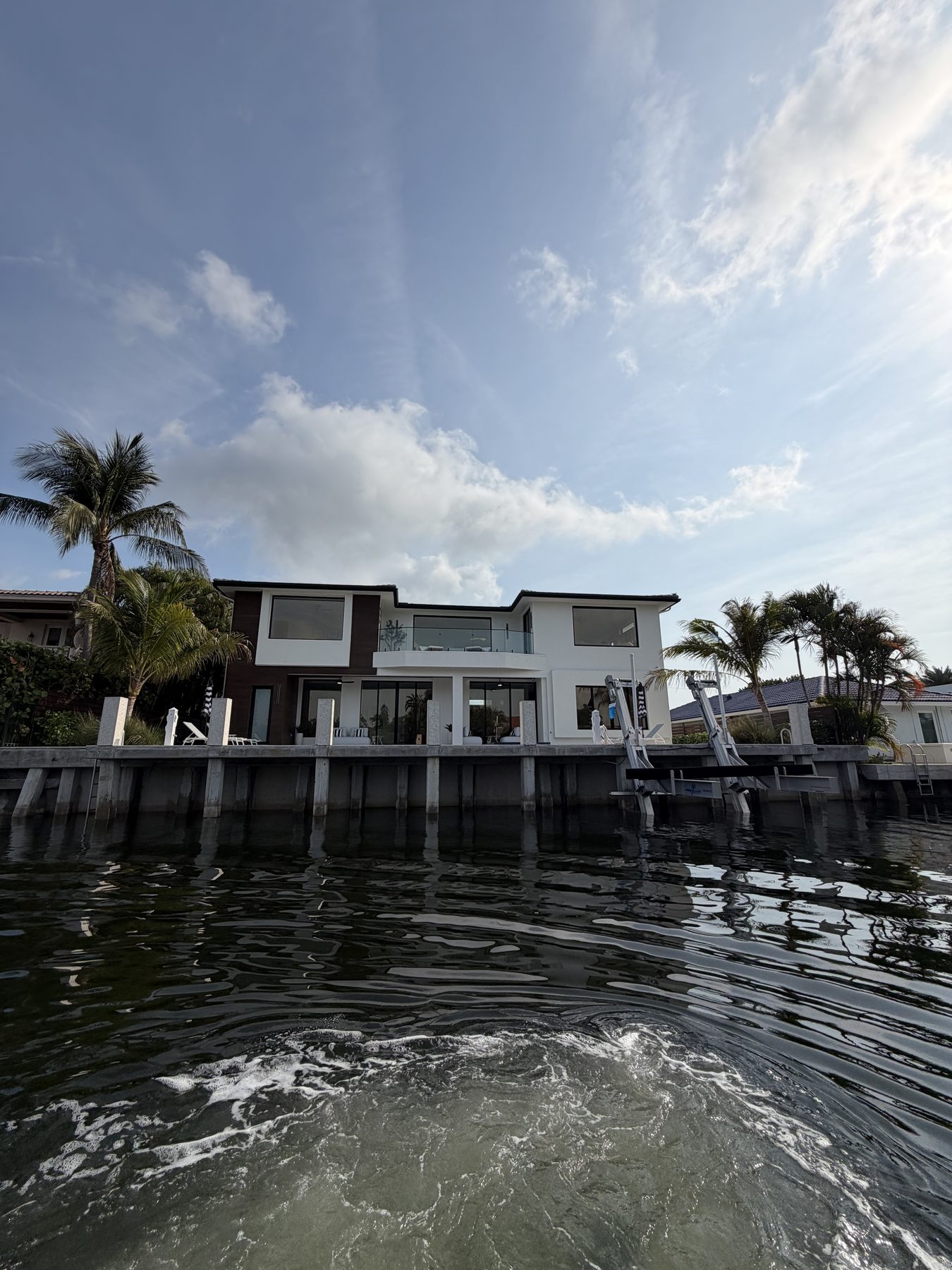 Modern luxury waterfront home in Boca Raton with engineered seawall and dual boat lifts
